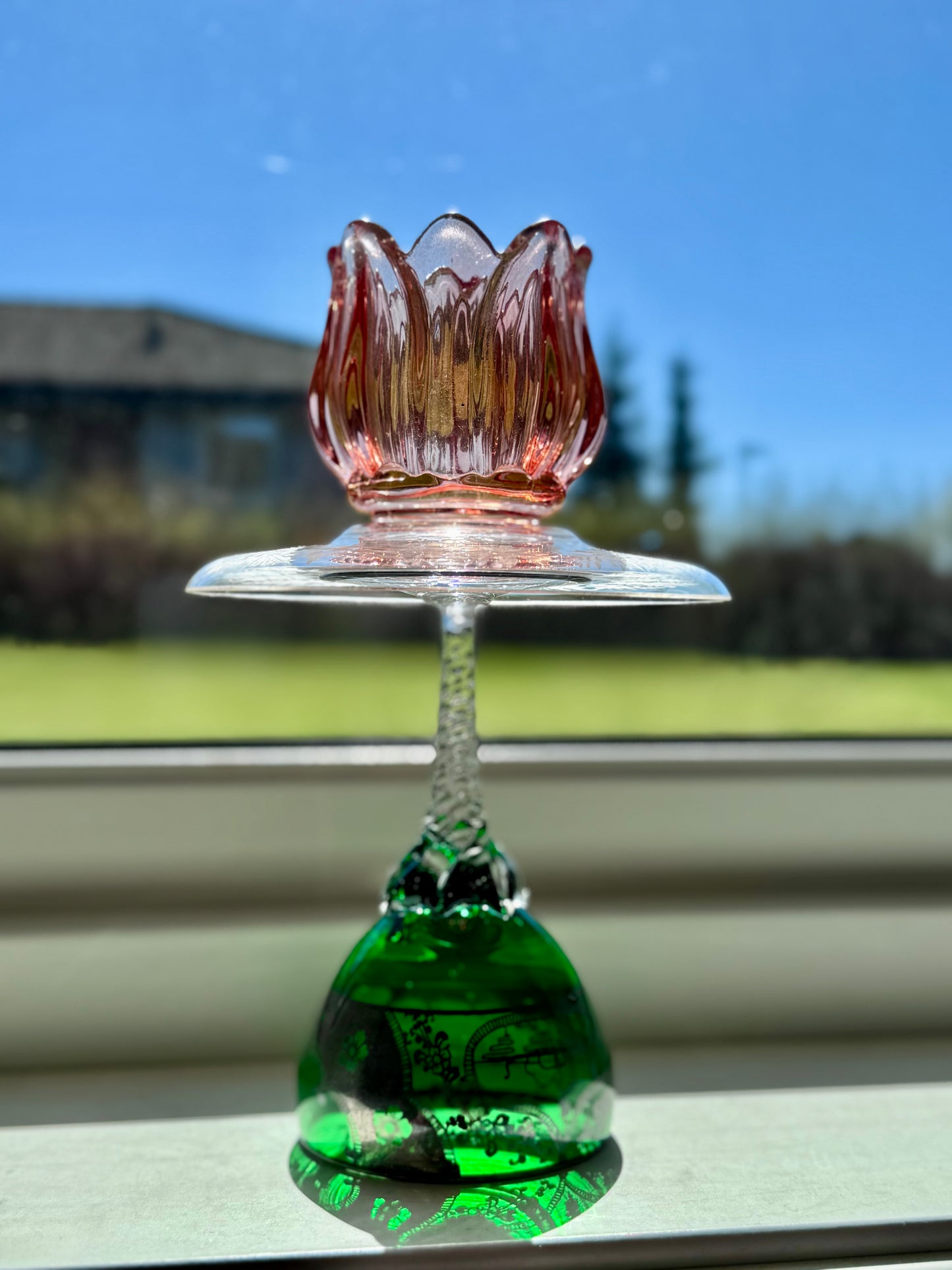 Vintage lysestake med flaskegrønn fot og rødoransje tulipan